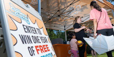 CoServ Community Engagement Team greeted Members in the CoServ Corral at the Flower Mound Arts Festival. Community Event Specialist Katie Moore talks to Members. Photo by BRIAN ELLEDGE